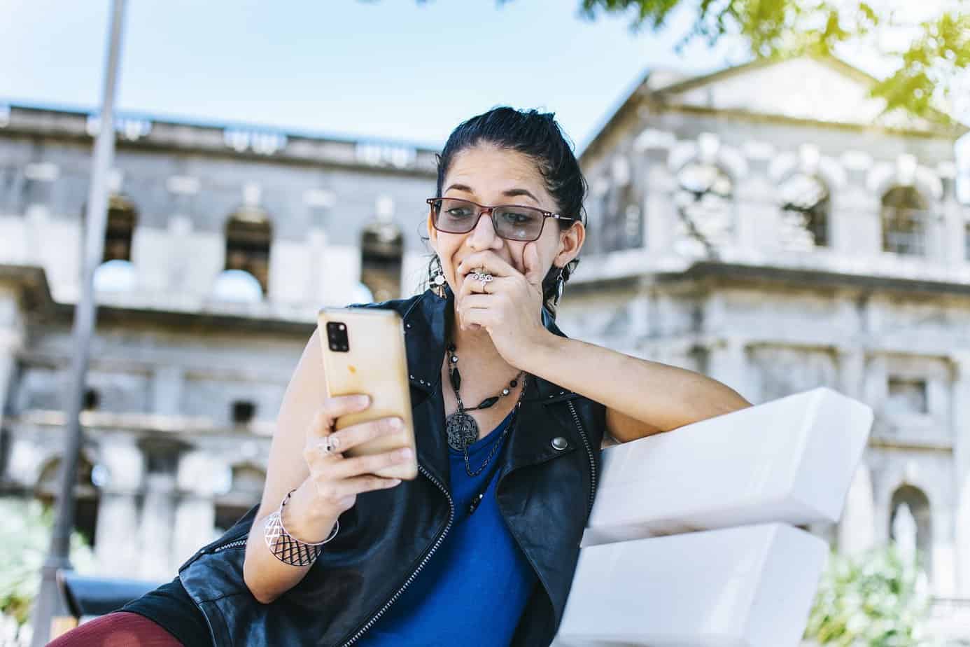 woman playing bubble games for money on a smartphone