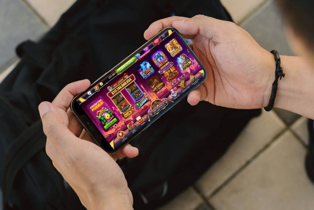 person playing Caesars Slots on a smartphone